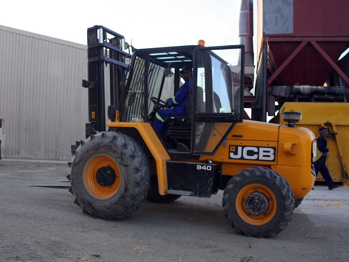 JCB rough-terrain forklift shown clearly in an outdoor industrial yard