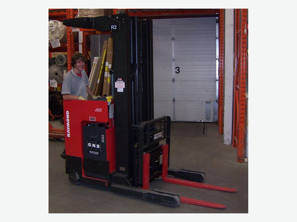 Raymond narrow-aisle reach stacker forklift shown clearly inside a warehouse